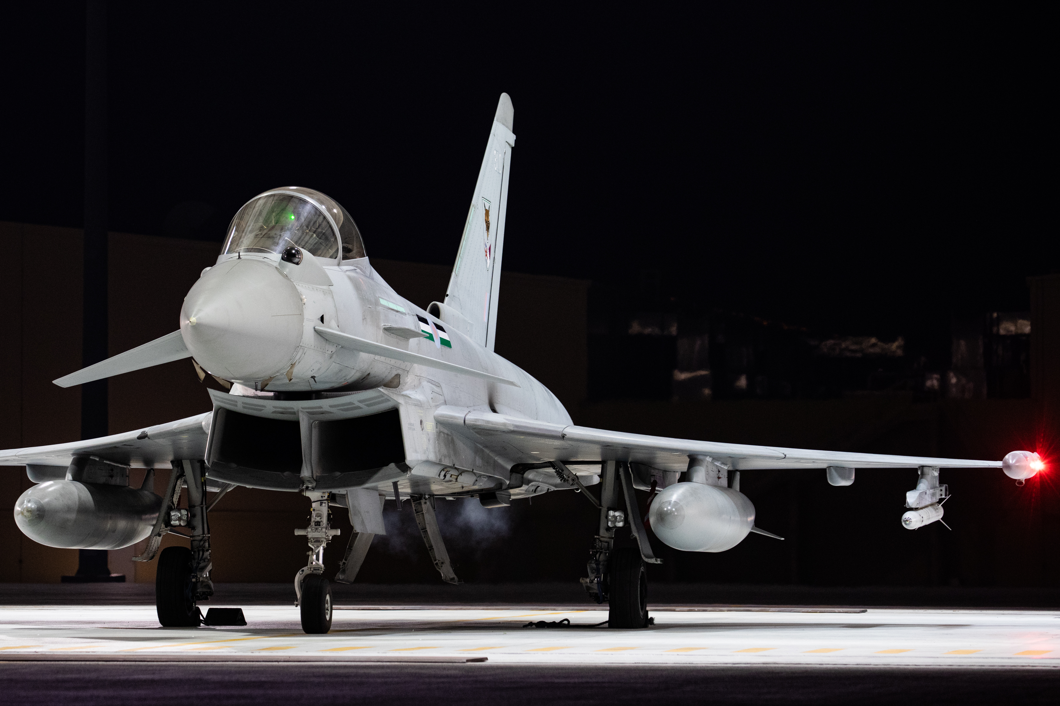 Image shows RAF Typhoon on the airfield at night.